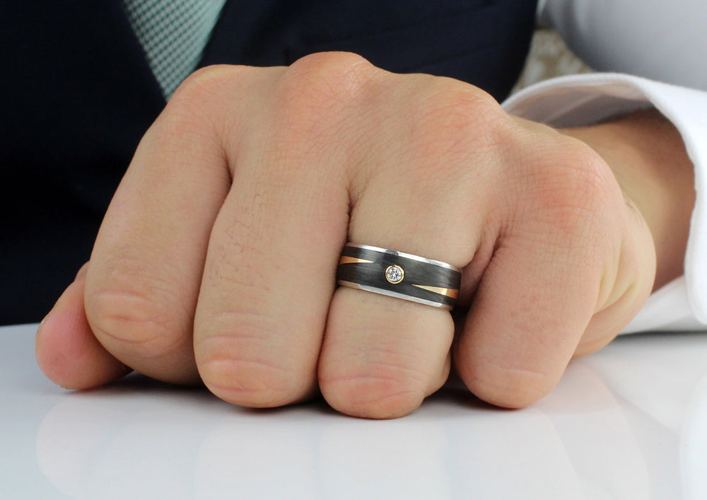Model wearing Palladium 18ct Rose Gold & Black Carbon Fibre ring set with 1 round 'brilliant cut' diamond, 0.04ct graded F/G 7mm wide, 1.7mm deep AVAILABLE NOW IN SIZE 55 (UK N 1/2)